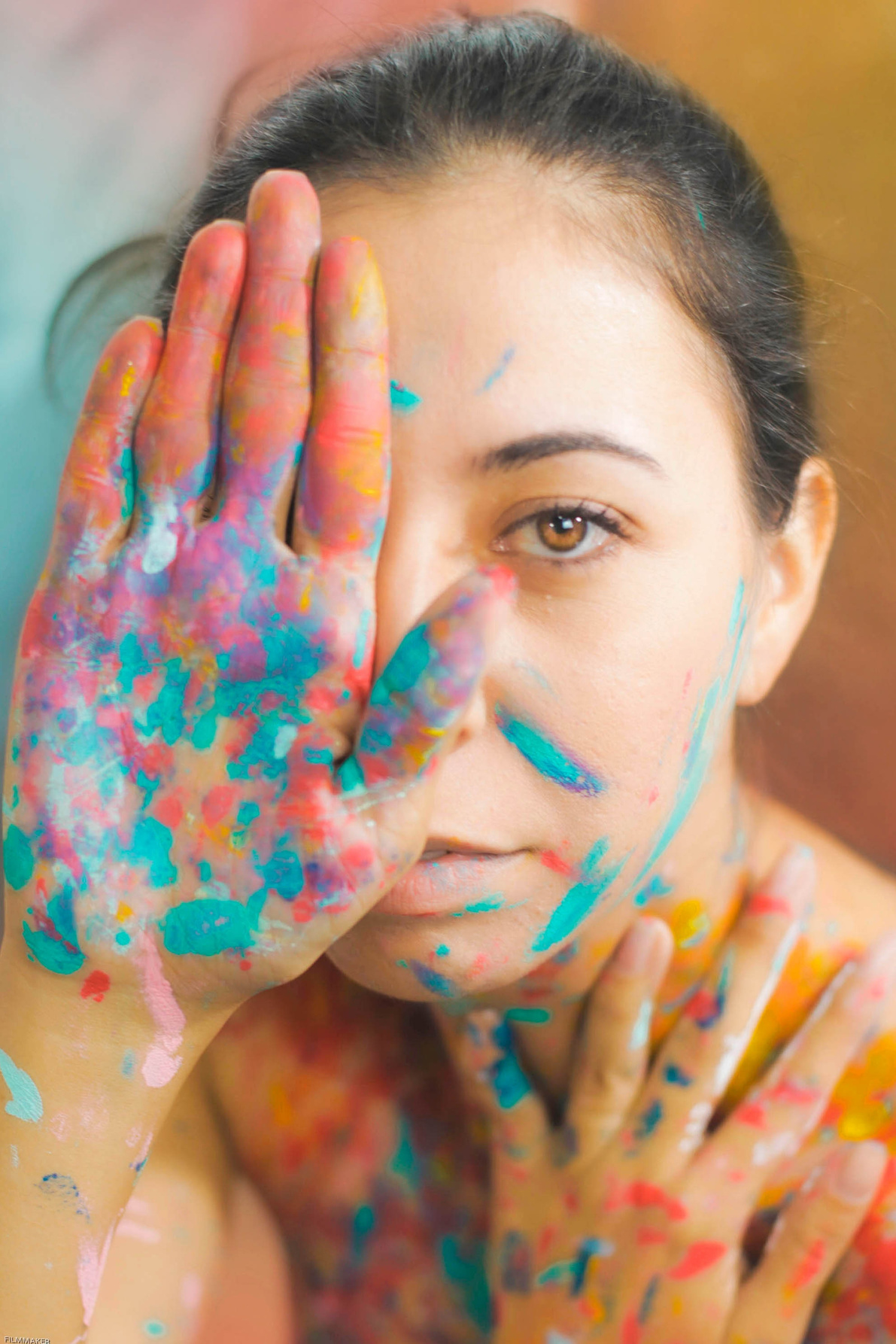 Female artist covering face with palm